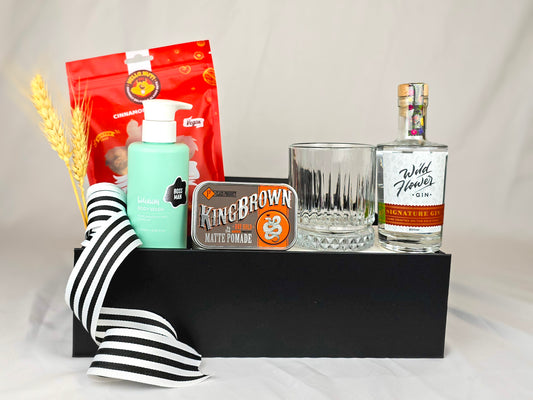 Gift hamper with gin, gin glass hair pomade, body wash and cinnamon cashews.