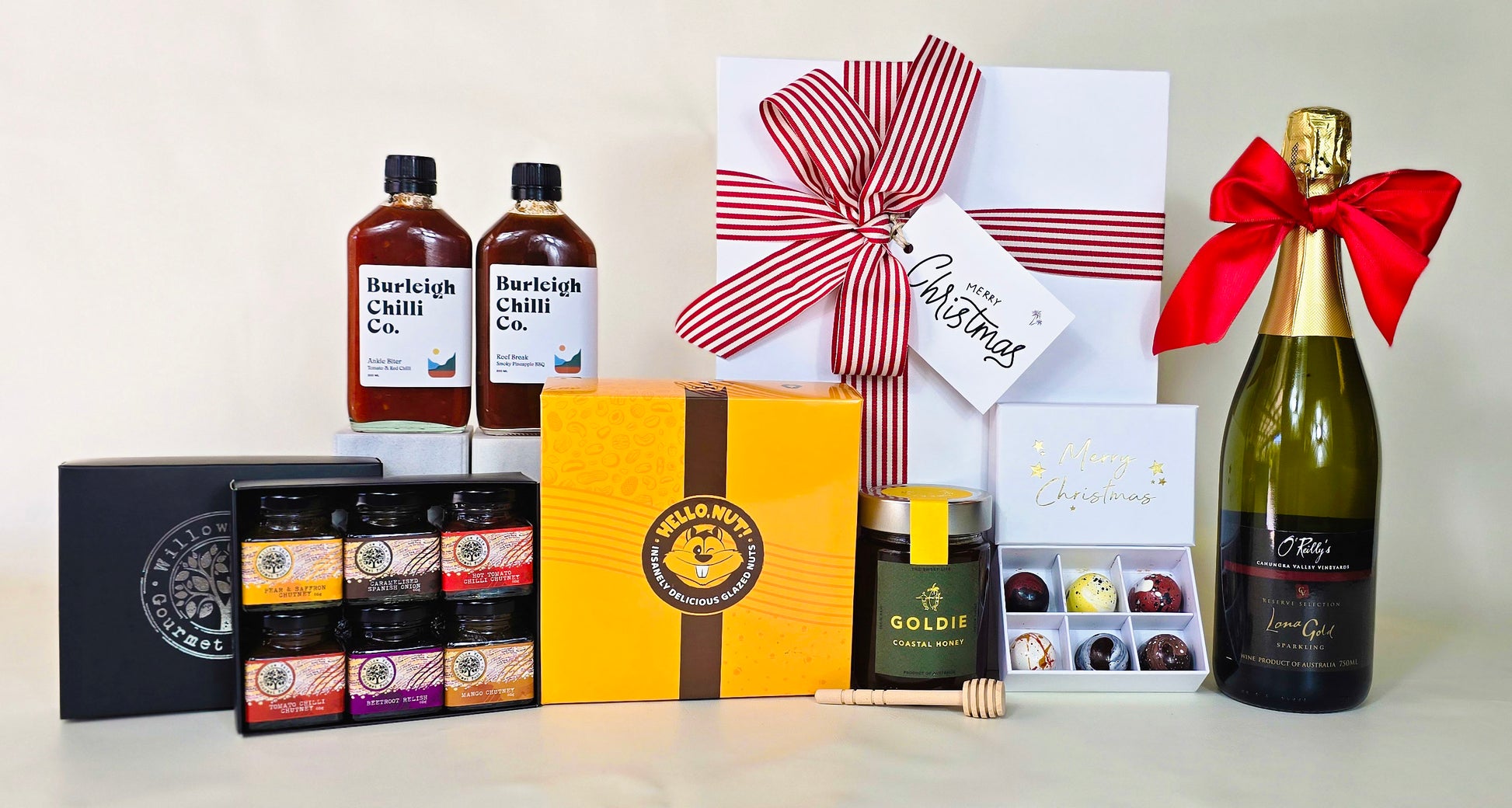 Collection of gift items including bottles, boxes, and a wine bottle with a bow on a white background