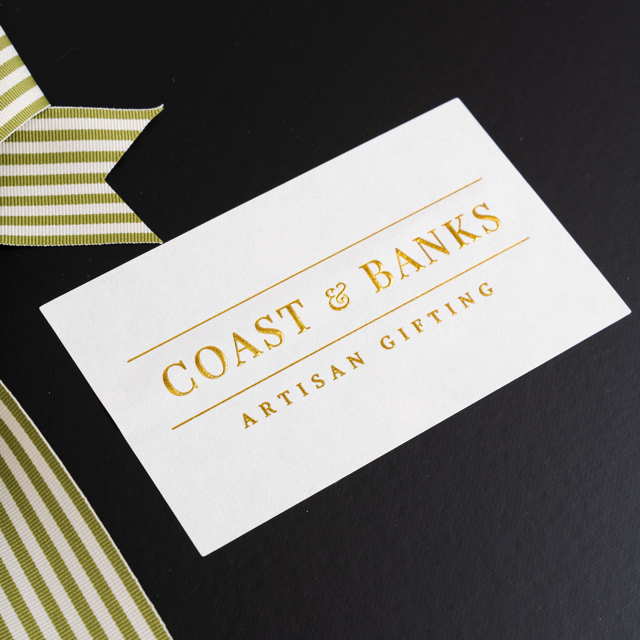 White card with 'Coast & Banks Artisan Gifting' text on a black background