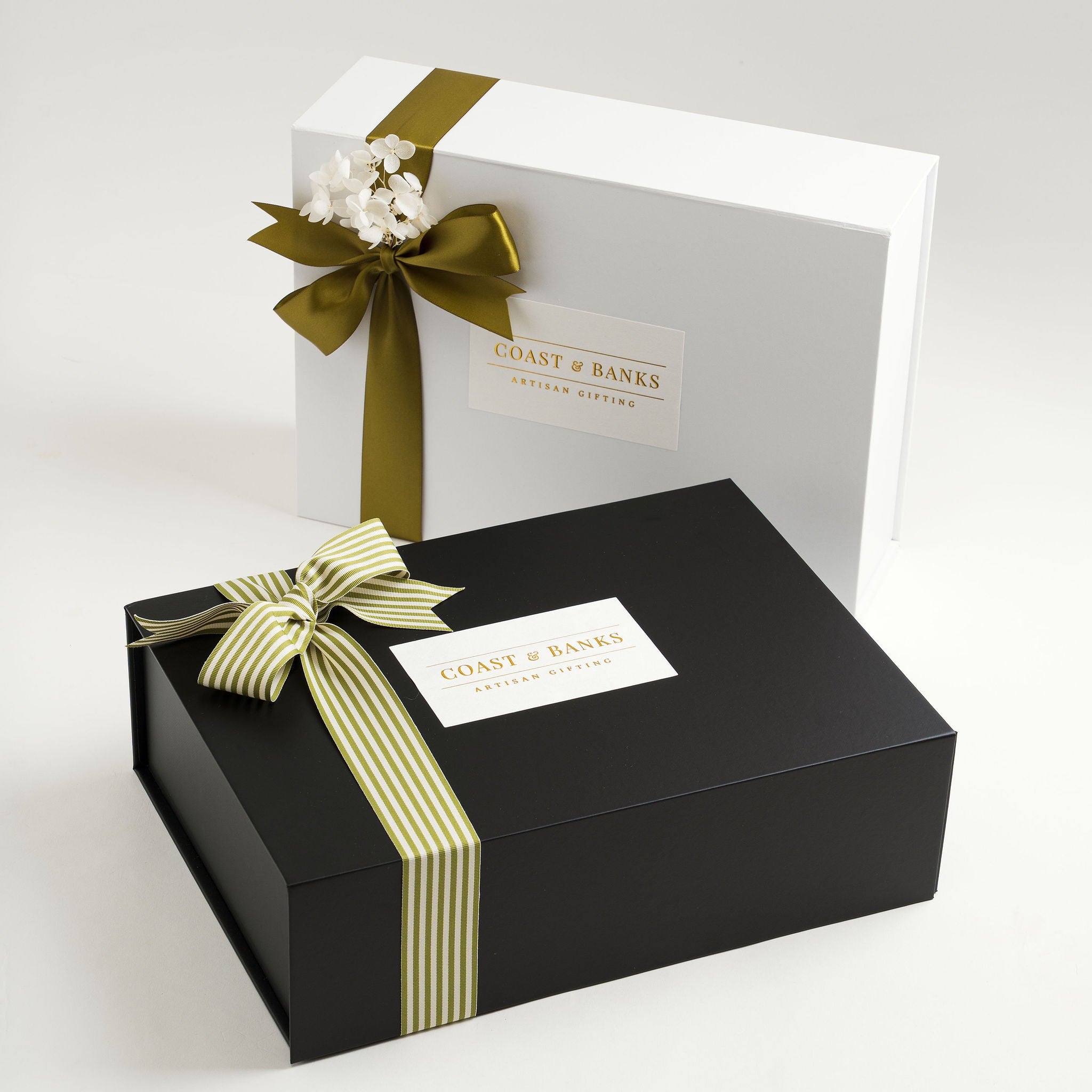 Two gift boxes with ribbons and 'Coast & Banks' labels on a white background ready for delivery Australia wide or locally Gold Coast.