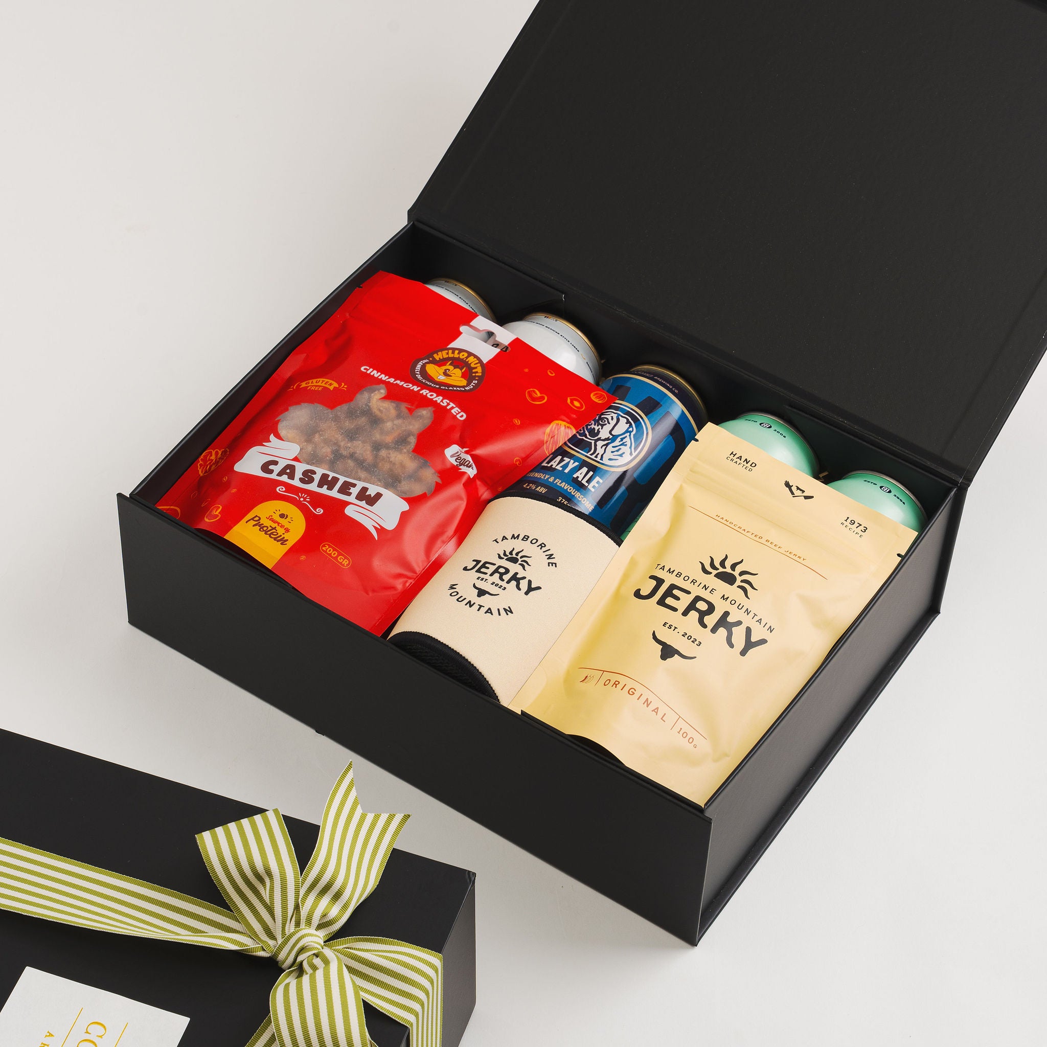 Gold Coast craft beer gift hamper with local brewery beers and gourmet snacks flat lay.