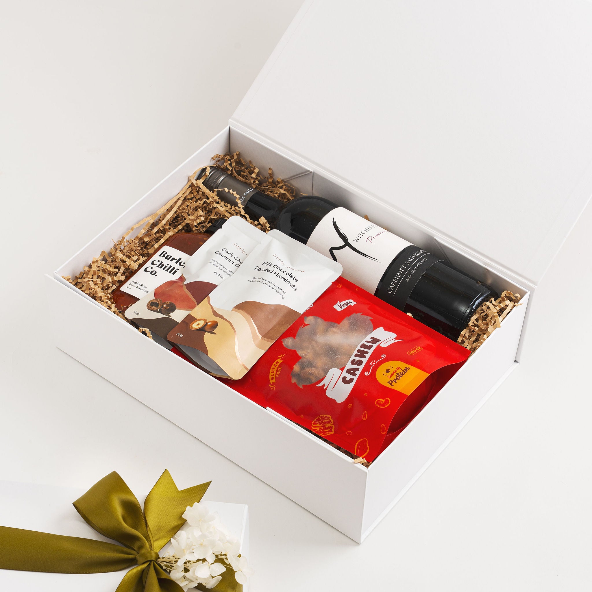 Luxury Gold Coast gift hamper with wine chilli sauce and gourmet snacks